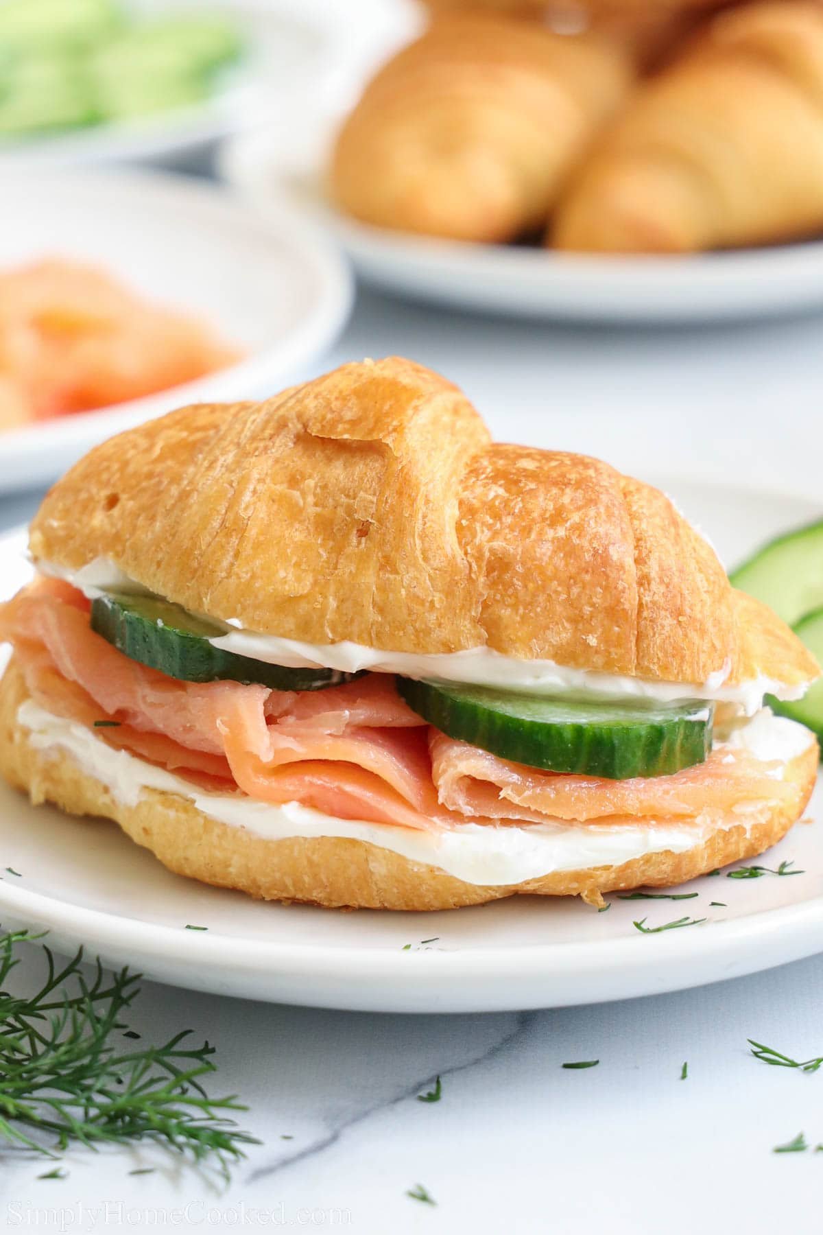 Smoked Salmon Sandwich on a croissant with cream cheese and cucumber.