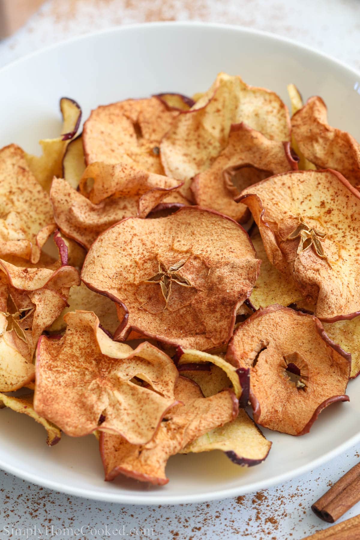 Close up of Crispy Air Fryer Apple Chips in a bowl.