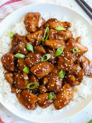Overview of a plate of Teriyaki Chicken on a bed of white rice.