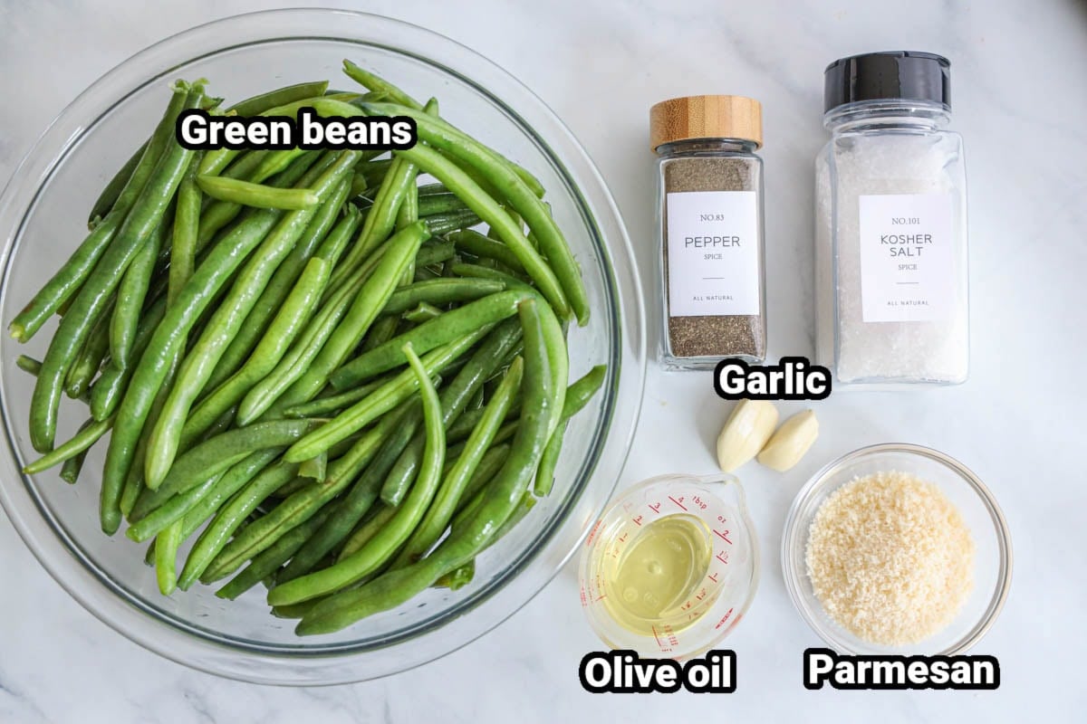 Ingredients for Roasted Green Beans: green beans, black pepper, kosher salt, olive oil, fresh garlic cloves, and parmesan cheese.