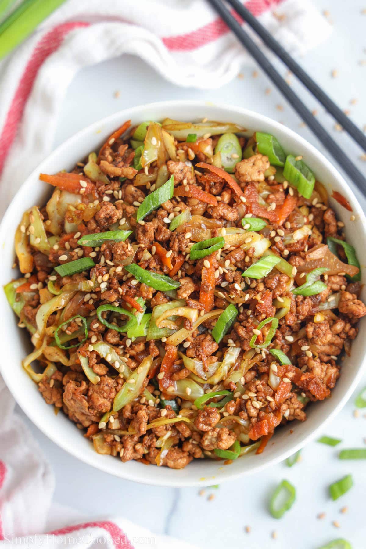 An overhead view of egg rolls in a bowl.