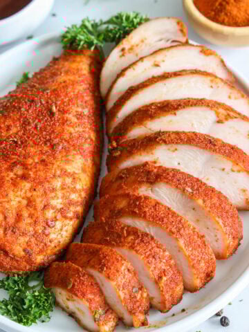 Smoked Chicken Breast on a plate, one sliced.