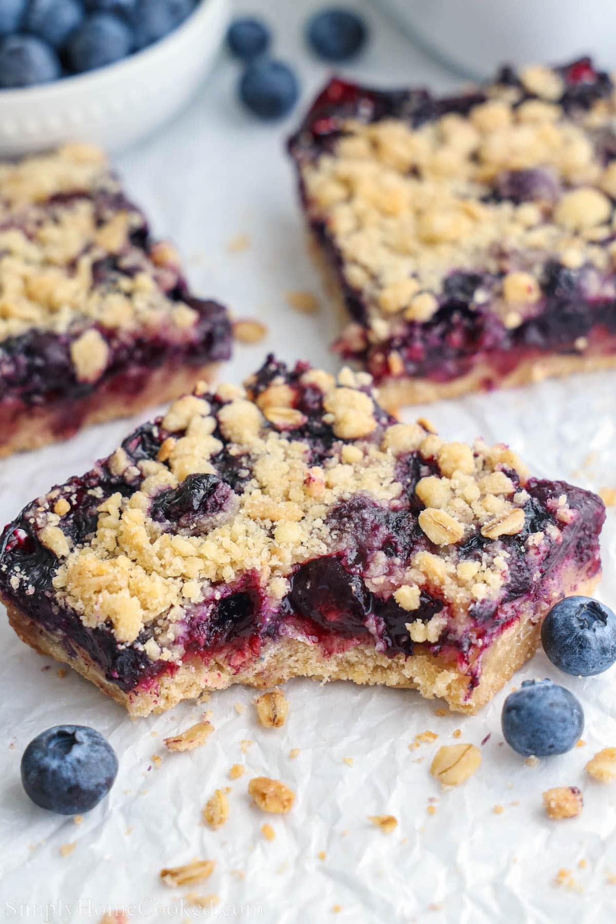 Close up of a Blueberry Crumb Bar, missing a bite.