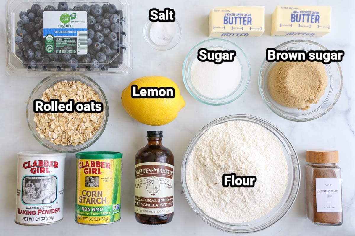 Ingredients for Blueberry Crumb Bars: blueberries, rolled oats, baking powder, cornstarch, vanilla, flour, lemon, sugar, salt, butter, brown sugar, and cinnamon.