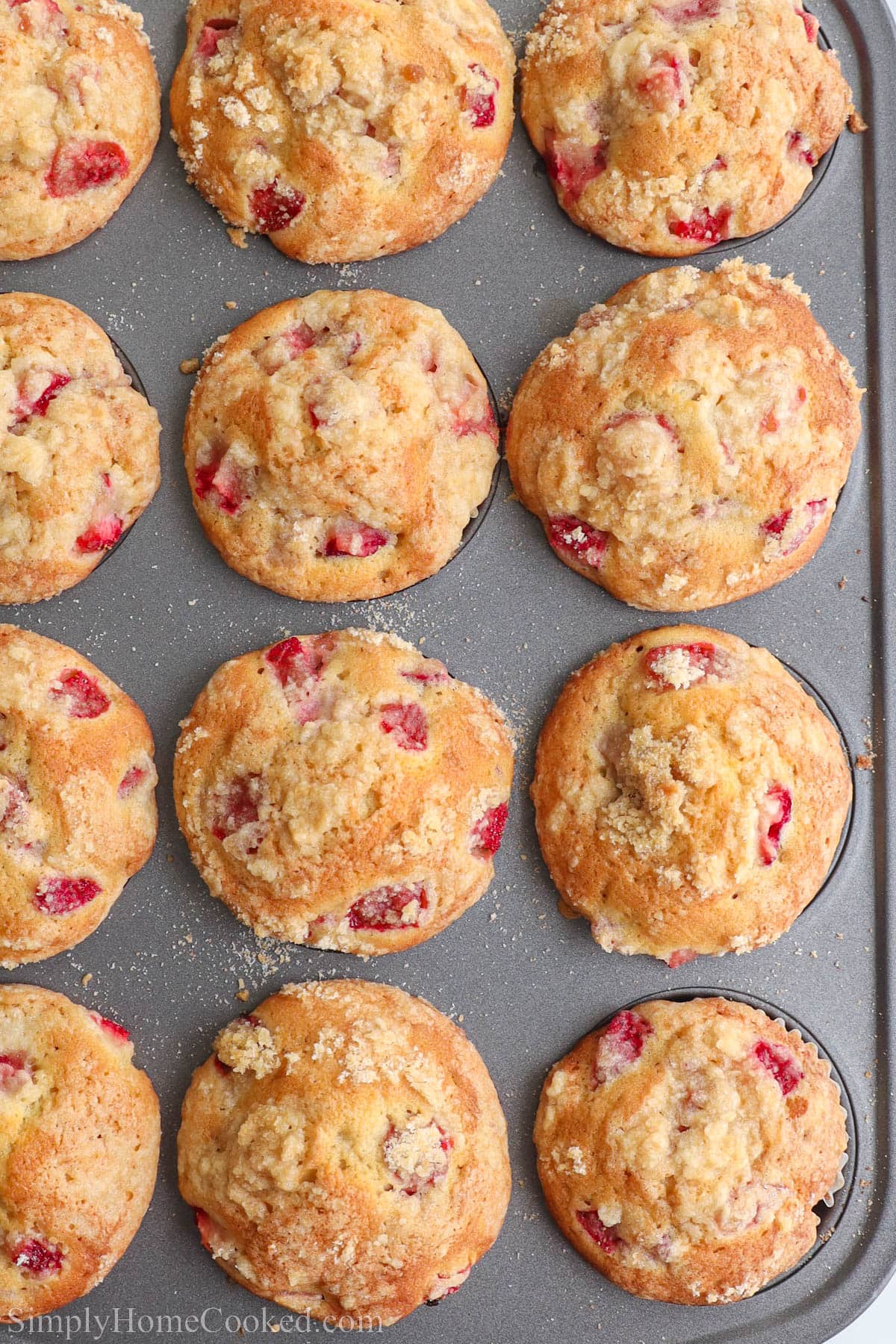 Strawberry Muffins in a gray muffin tin.
