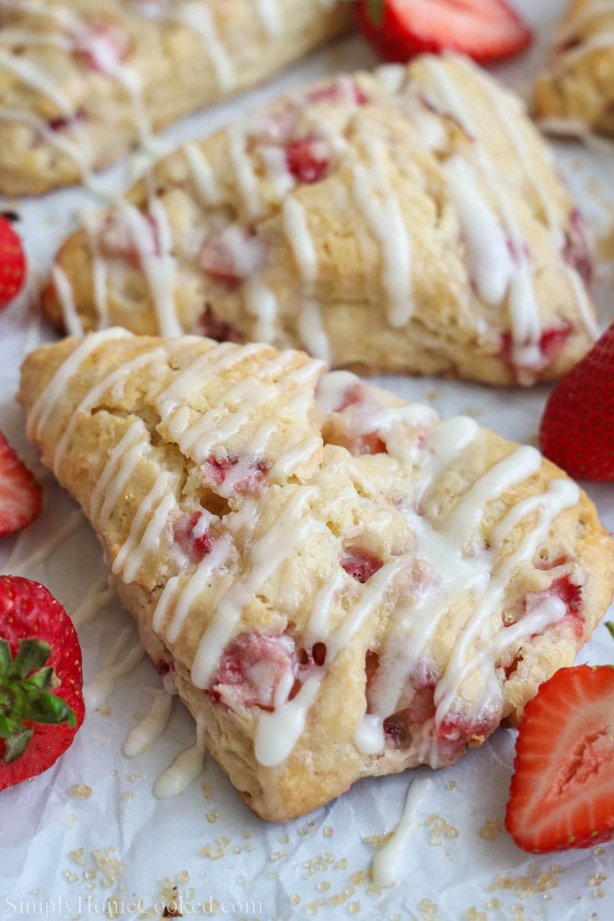 Close up of Strawberry Scones drizzled with vanilla icing.