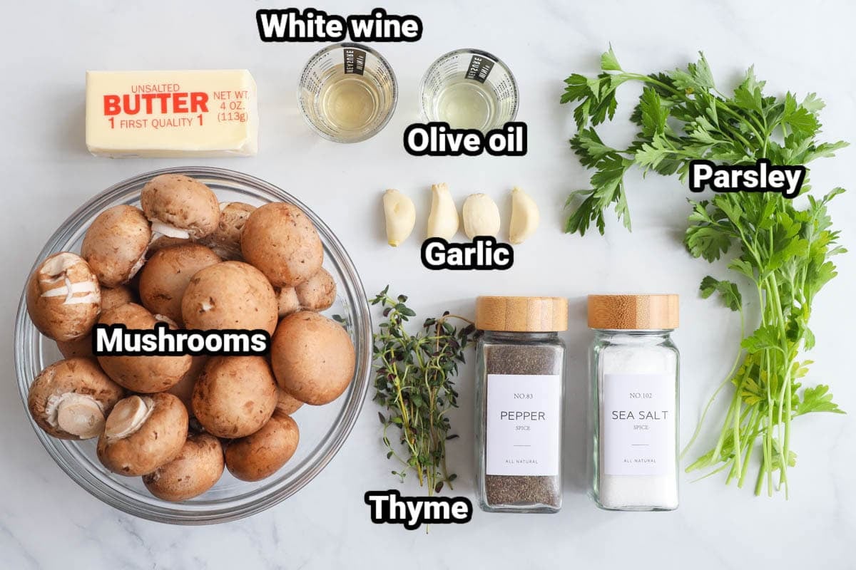 Ingredients for Garlic Butter Mushrooms: baby bella mushrooms, garlic cloves, white wine, butter, olive oil, parsley, thyme, pepper, and salt.