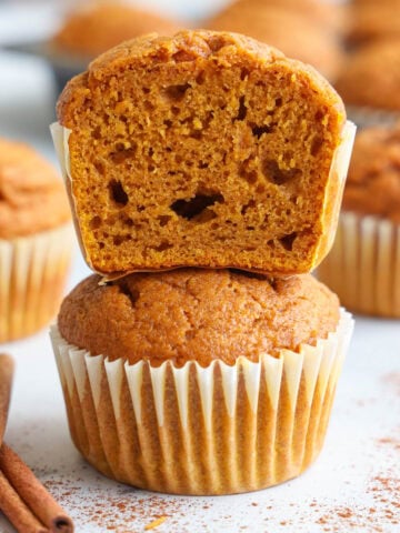 Stack of Pumpkin Muffins, the top one cut in half.