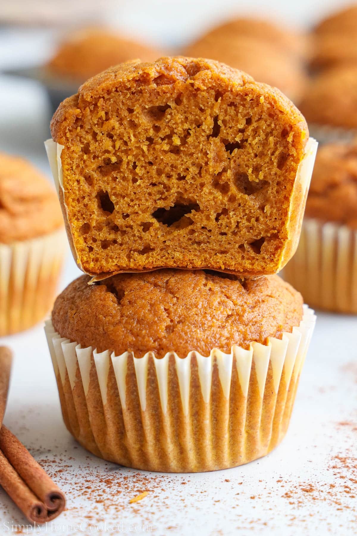Stack of Pumpkin Muffins, the top one cut in half.