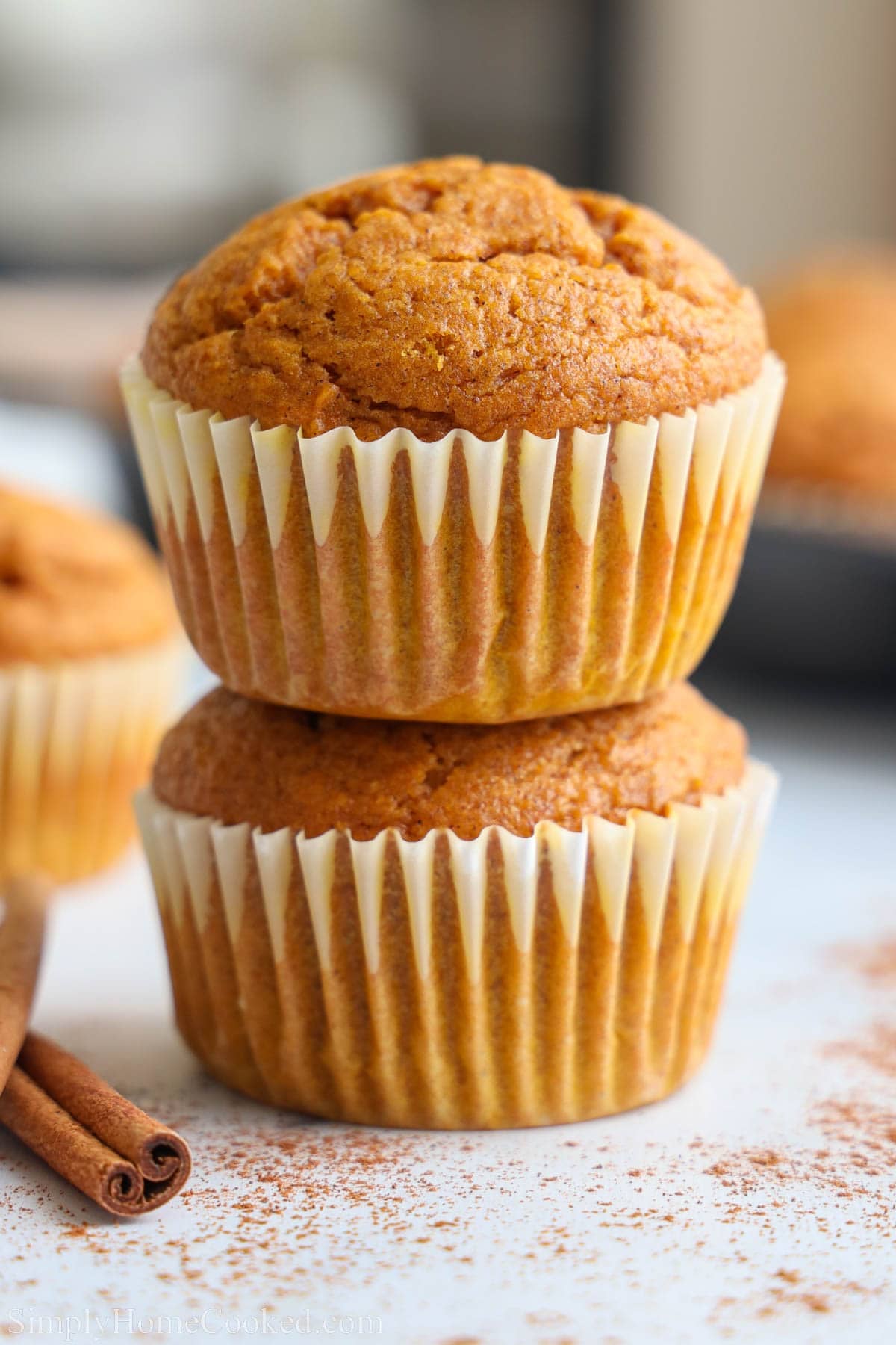 Two Pumpkin Muffins are stacked on top of each other.